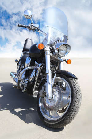 big black motorcycle on asphalt against  skyの写真素材