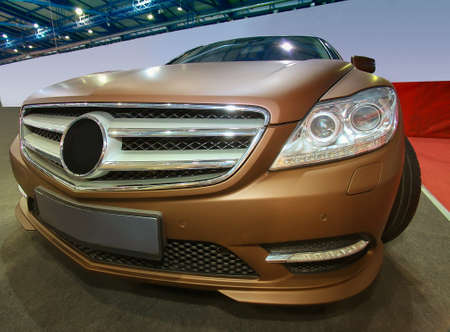 dark-golden modern luxury car on auto showの写真素材