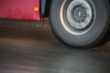 wheel of  bus going on highway close upの写真素材