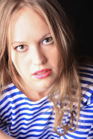 smiling beautiful young woman in striped hoodieの写真素材