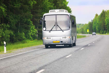 silvery bus goes on the country highwayの写真素材