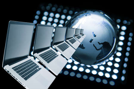 laptops row and the glass globe on black backgroundの写真素材