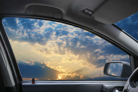 Heavenly landscape behind  car windowの写真素材