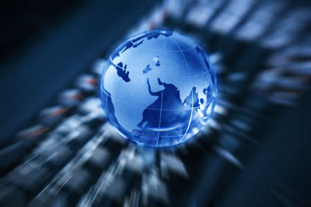 transparent glass globe on the laptop keyboardの写真素材