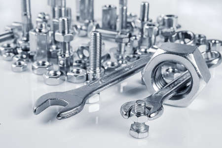 wrenches bolts and nuts on white backgroundの写真素材