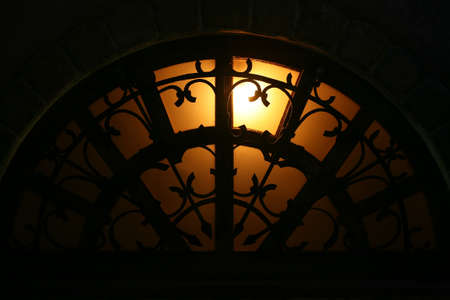 arch window with the forged lattice at nightの写真素材