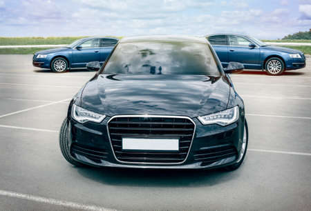 three cars on asphalt against the skyの写真素材