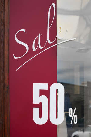 show-window of shop with text about sale at discount