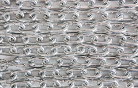 ranks of brilliant chromeplated chain on white backgroundの写真素材