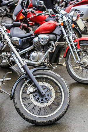 many motorcycles on parking on asphalt  close upの写真素材