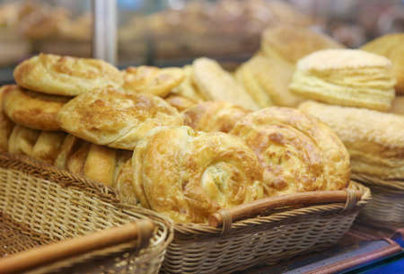 roll cheese cakes in baskets on bakery counterの写真素材