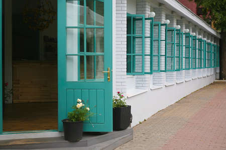 white brick wall with open windowsの写真素材