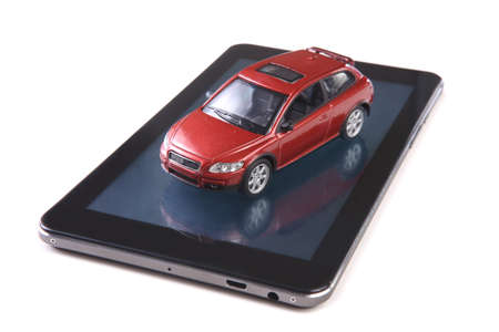 red toy car on tablet isolated on whiteの写真素材