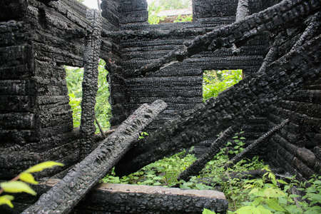 interior of burned-down wooden log houseの写真素材