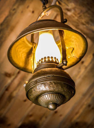 ancient kerosene metal lamp indoorsの写真素材