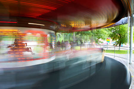 roundabout rotating in children's park in afternoonの写真素材