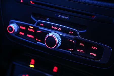 automobile radio receiver which is switched on shining red lightの写真素材