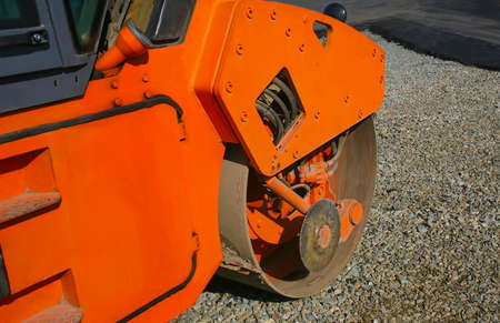 steamroller condensing asphalt and crushed stone on new road