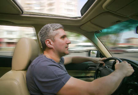 driver goes to car on city streetの写真素材