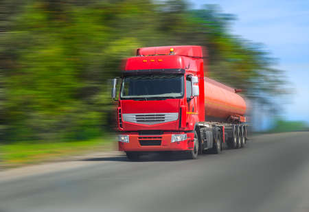 red fuel truck transports fuel to country highwayの写真素材