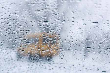 winter road through wet glass of carの写真素材
