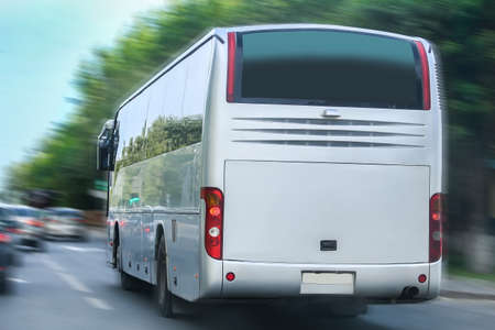 big tourist bus goes on  city streetの写真素材