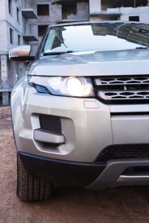 SUV close up before building under constructionのeditorial素材