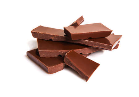 chocolate pieces isolated on white backgroundの写真素材