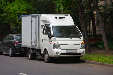 white truck on street near residential buildingの写真素材