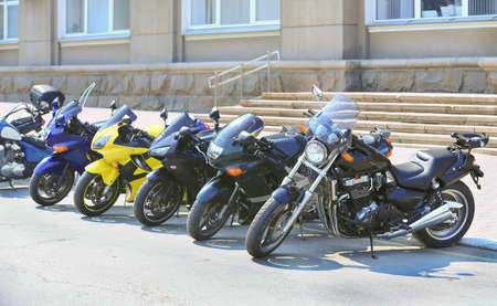 different motorcycles on parking on asphalt  close upの写真素材