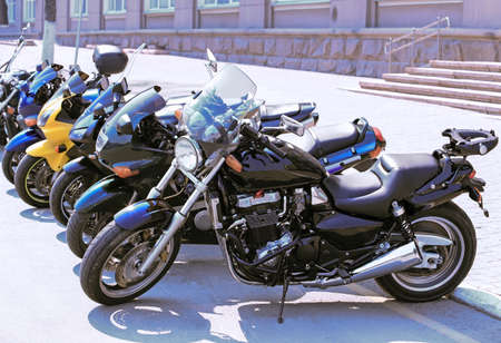 different motorcycles on parking on asphalt  close upの写真素材