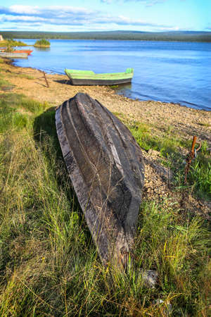 wooden boats on bank of lake in summerの写真素材
