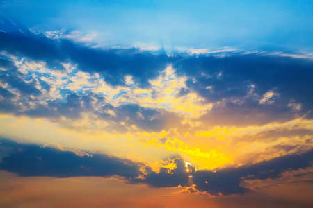 beautiful bright sunset in cloudy skyの写真素材