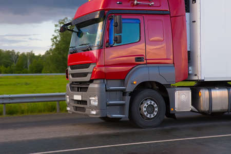 red truck transports freight on the highwayの写真素材