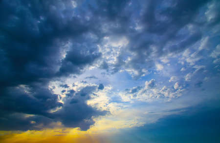 beautiful bright sunset in cloudy skyの写真素材
