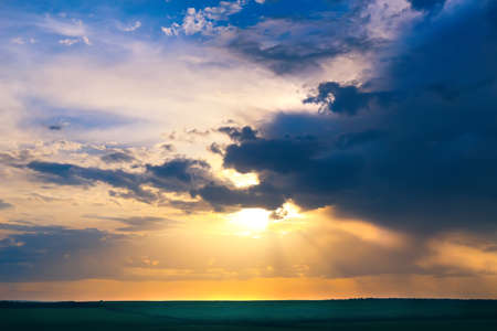 beautiful bright sunset in cloudy skyの写真素材