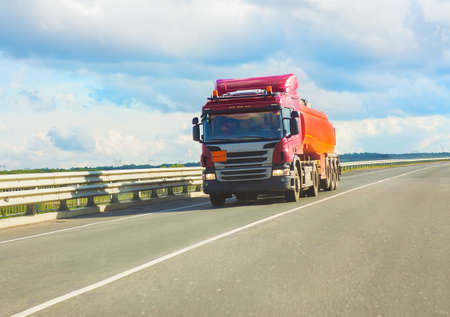 red fuel truck transports fuel to country highwayの写真素材