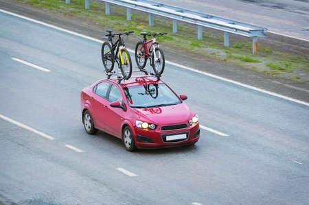 car with two bicycles on the top luggage carrierの写真素材