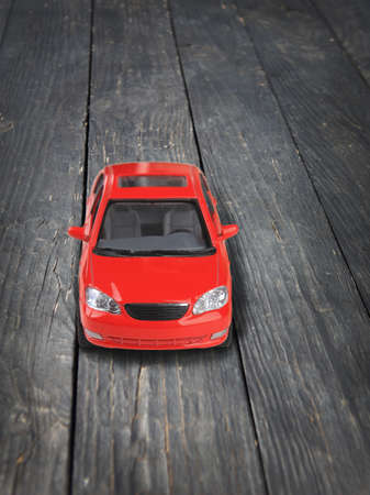 red toy car on timber floorの写真素材