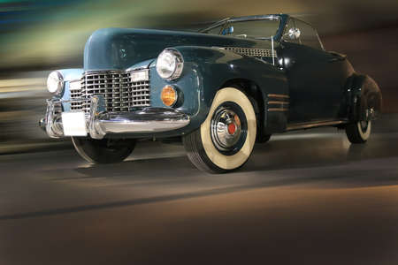 retro car moves on city street at nightのeditorial素材