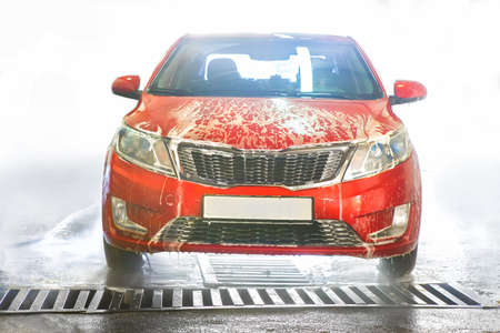 car covered with foam on car wash