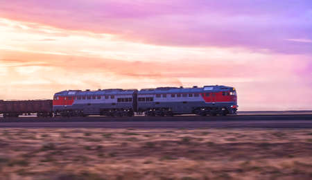 locomotive moves by rail in evening on sunsetの写真素材