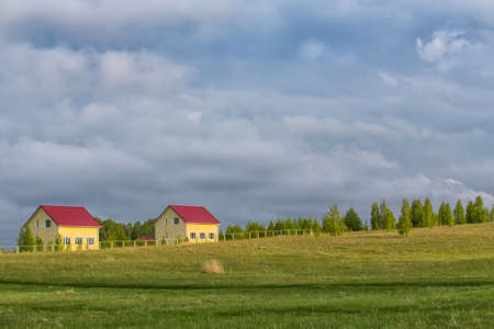 new cottages in the country in the field near the woodの写真素材