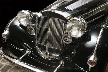 ancient luxury black car against dark backgroundの写真素材