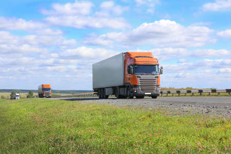 escort of trucks moves on the country highwayの写真素材
