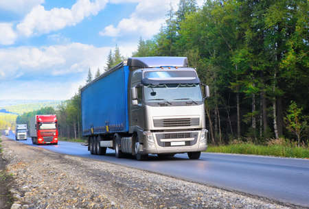 escort of trucks moves on the country highwayの写真素材