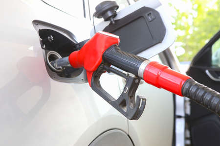 handle of the filling gun in car gasoline tankの写真素材