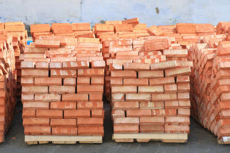 red bricks laid in pallets outsideの写真素材