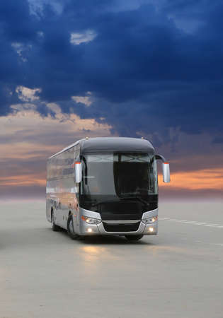 modern tourist bus on asphalt in the evening on sunsetの写真素材