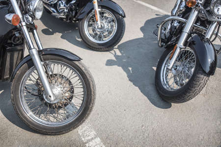 many motorcycles on parking on asphalt  close upの写真素材